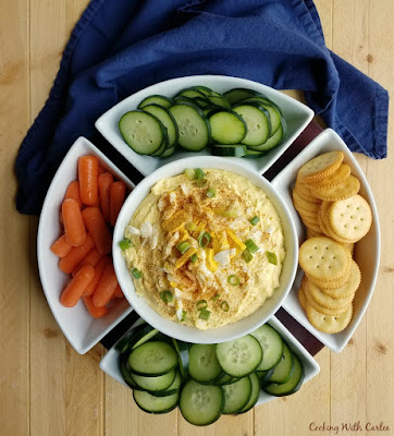 Do you love deviled eggs, but hate the pressure to make them perfect? Deviled egg dip gives you the flavor without worrying about peeling pretty eggs! bird's eye of big serving dish with dip, veggies and crackers
