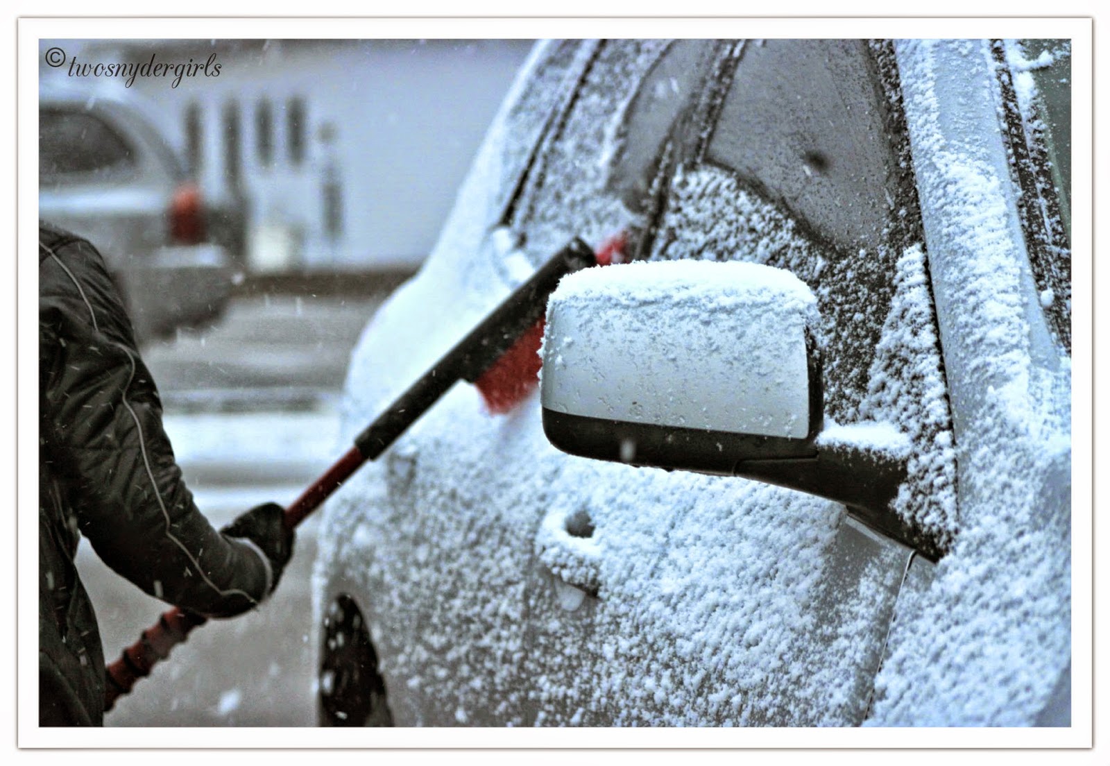 brushing snow off car