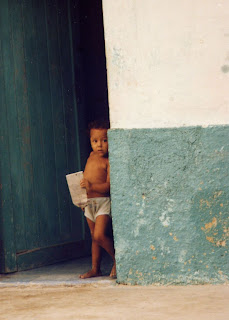 little boy standing in doorway Isla Mujeres Mexico