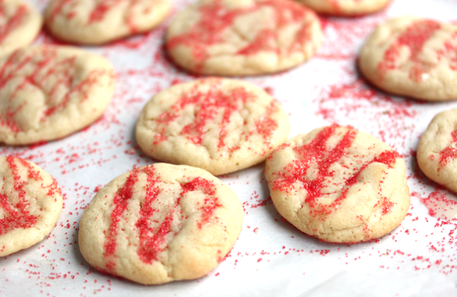 Eggnog Iced Butter Cookies sprinkled with red sprinkles.