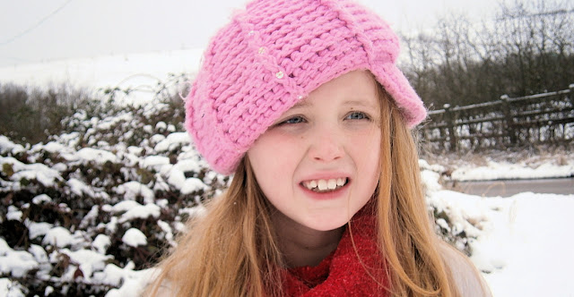 pink hat pretty girl in snow uk