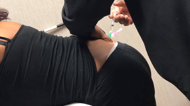 Pregnant woman being injected by a doctor