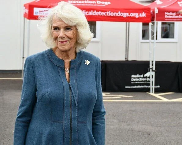 The Duchess of Cornwall wore a denim dress from Fiona Clare, and a neutral handbag and shoes. She wore her FitBit watch and some gold jewellery