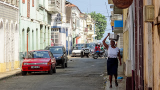 Woman carries a bucket through the streets