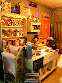 Close up view of a modern shabby chic shop, showing the counter area with plate racks behind it.