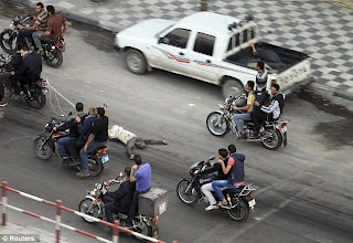 Palestinians drag body of suspected spy behind motorcycles in Gaza Palestinians drag body of suspected spy behind motorcycles in Gaza