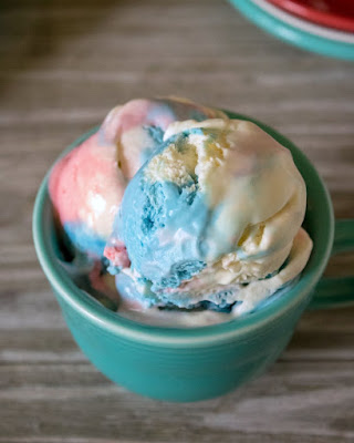 This red, white and blue no churn ice cream is super easy to make and so patriotic. Make a batch for Memorial Day, Independence Day and Veteran's Day. Then go ahead and make a batch for all of the days in between as well! bowl of red white and blue ice cream ready to eat