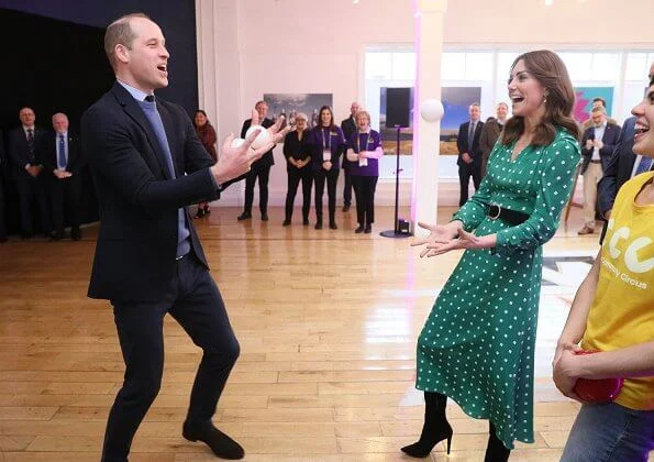 Kate Middleton wore a green midi dress by Suzannah. Alexander McQueen khaki long coat and Jimmy Choo boots