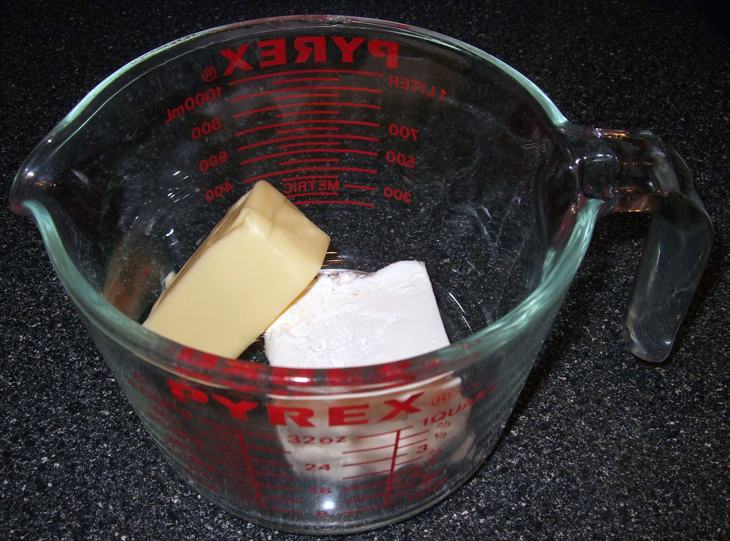 Cream cheese and butter in measuring cup.