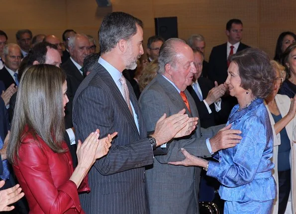 Queen Letizia wore Uterque red Leather jacket and Uterque beige pumps, Queen carried Uterque clutch bag, wore Hugo Boss skirt