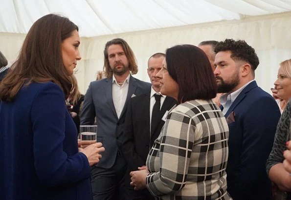 Kate Middleton wore Goat Ellory Bow Detail Coat. Duchess Catherine of Cambridge carried Beulah London Aspinal Blue Heart Clutch