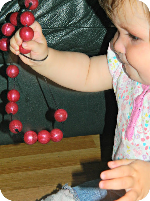 Baby girl playing with the Gumigem Bubba Beads Pipsqueak