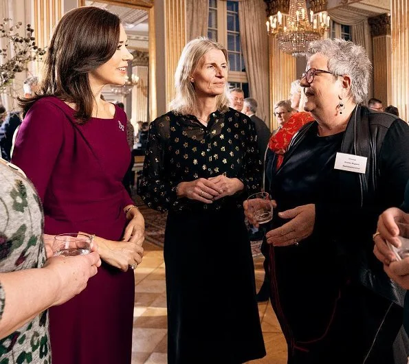 Crown Princess Mary wore Prada purple knee-length dress. The Princess hosted a Christmas reception for Mary Fonden. She wore her Prada purple dress