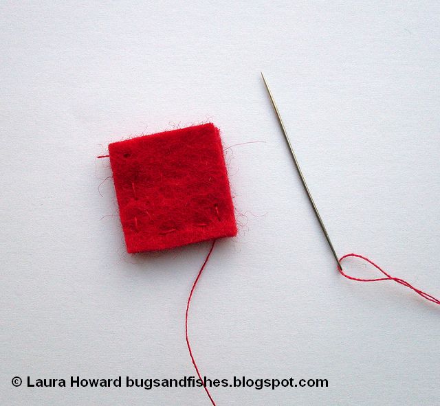 sewing the base of a felt Christmas tree ornament