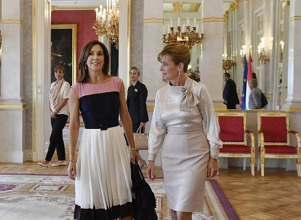 Crown Princess Mary of Denmark wore a white black plated skirt and pink blue top at Regional Committee for Europe meeting