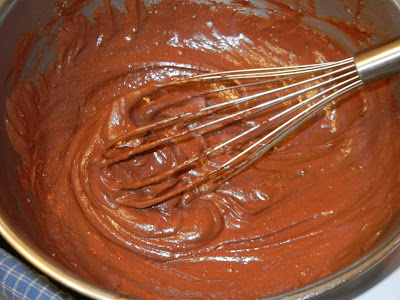 brownie batter in metal bowl with a metal whisk 