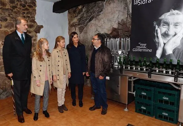 Crown Princess Leonor and Infanta Sofia wore Carolina Herrera trench coat, Mango Prince of Wales trousers. Queen Letizia