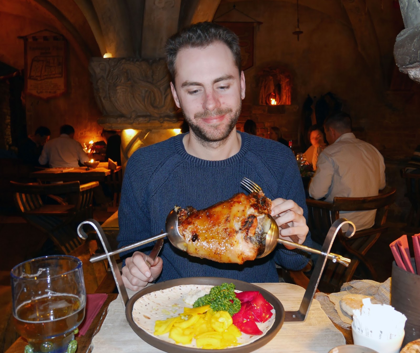 Stuart eating roast pork at Rozengrāls Medieval Restaurant in Riga, Latvia
