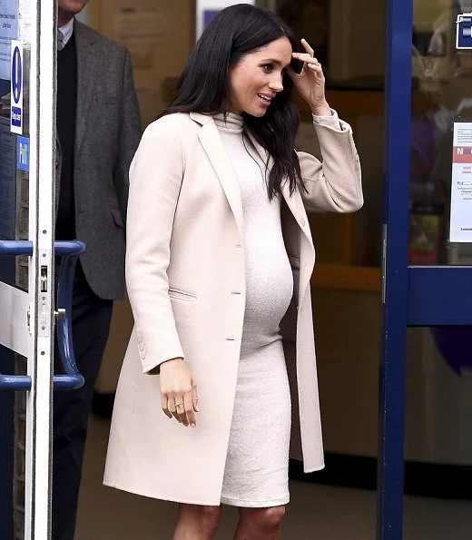 Meghan Markle wore Emporio Armani coat, and H&M Mama fine-knit dress, Paul Andrew pumps and carrie Stella McCartney bag