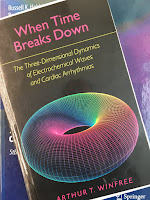 When Time Breaks Down: The Three Dimensional Dynamics of Electrochemical Waves and Cardiac Arrhythmias, by Arthur Winfee, superimposed on Intermediate Physics for Medicine and Biology.