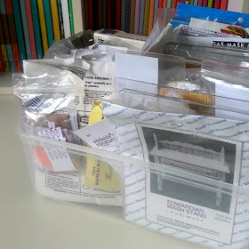 Plastic box full of kits for one-twelfth scale modern miniatures.