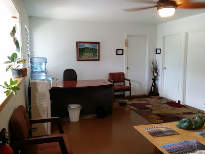 Reception area of a healing arts center with artwork and water cooler.