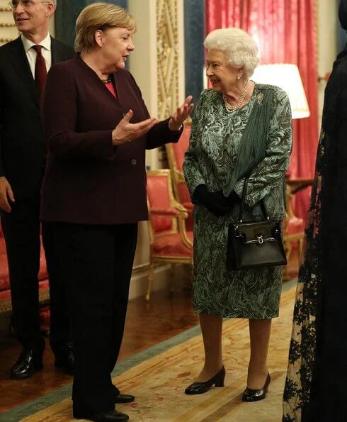 Kate Middleton wore a new emerald-green dress by Emilia Wickstead. The Duchess of Cornwall and First Lady Melania Trump