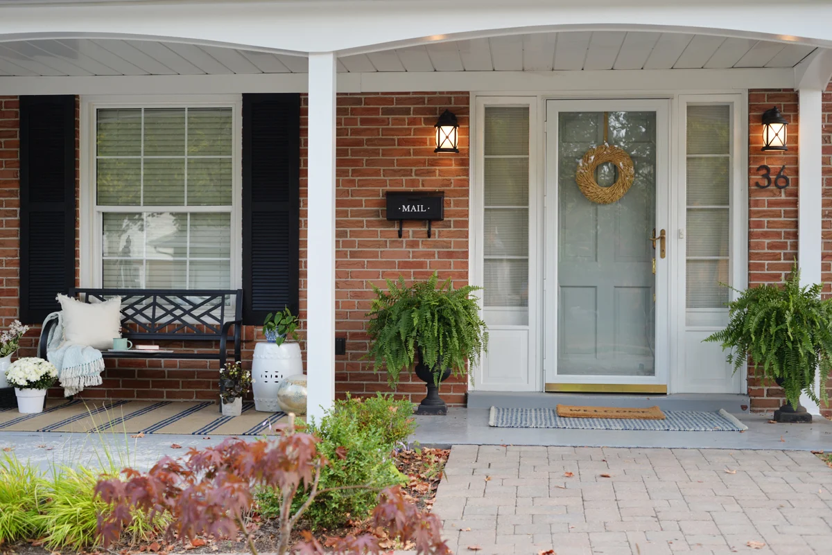 front porch decorating ideas for summer, fresh traditional front porch decor with sitting bench and striped Annie Selke rug