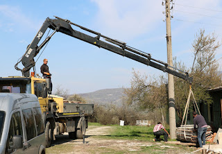 The crane had a very long unloading arm The crane had a very long unloading arm