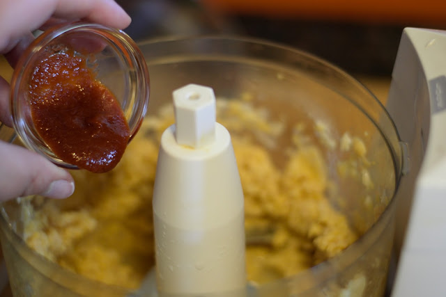 Sriracha being added to the food processor.  
