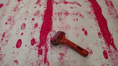 picture of magenta paint rolled onto paper using a small brayer