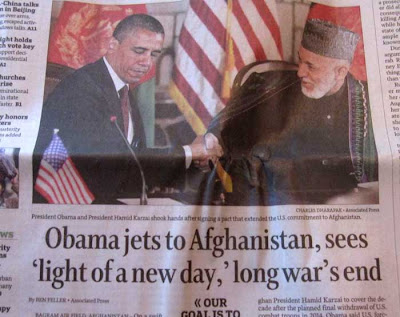 Obama jets to Afghanistan, sees 'light of new day,' long war's end