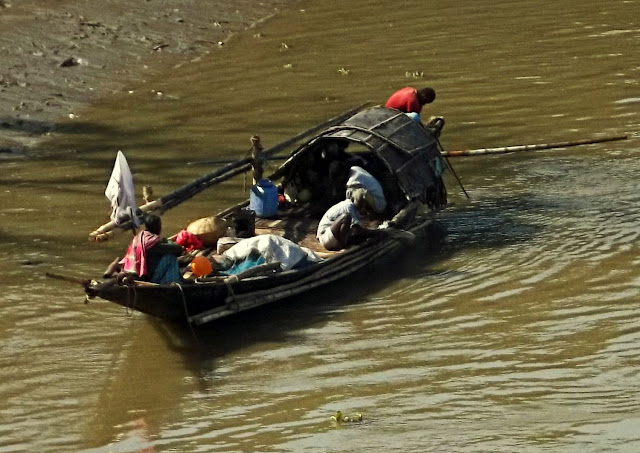 men on boats on river
