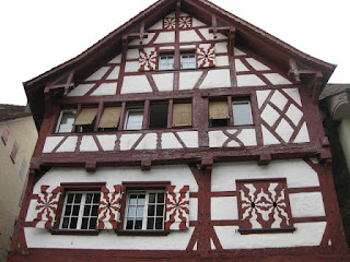 Building with red beams, white walls, and shutters, Stein am Rhein, Switzerland.
