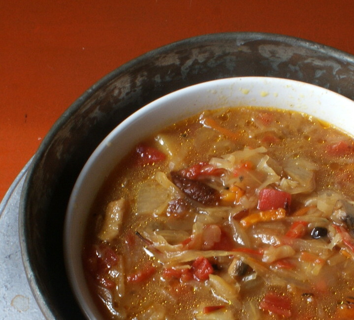 Red and spicy sauerkraut soup with mushrooms