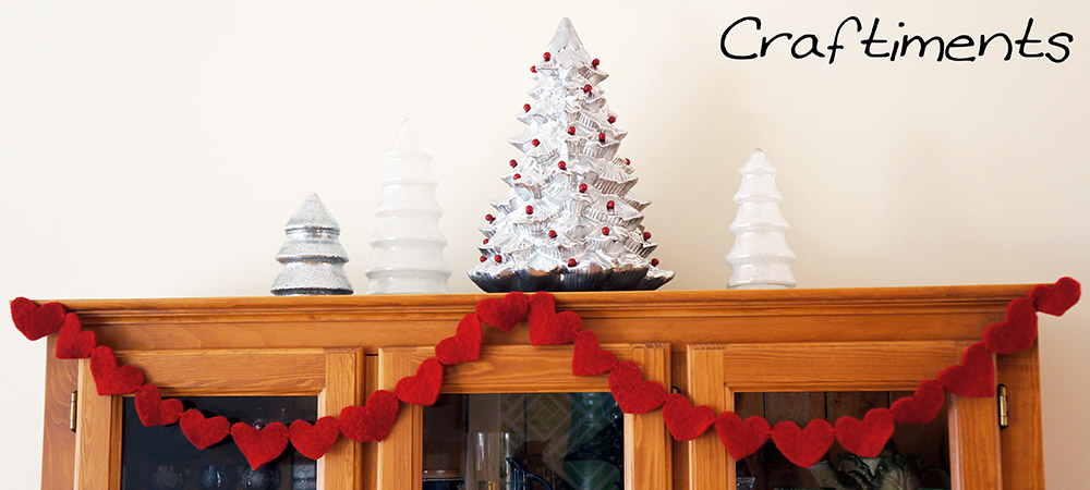 Craftiments:  Glittered tree-shaped candy jars, thrifted ceramic Christmas tree, heart garland