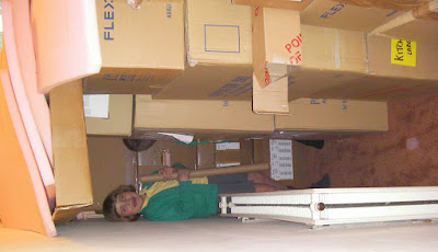 children hiding amongst cardboard packing boxes