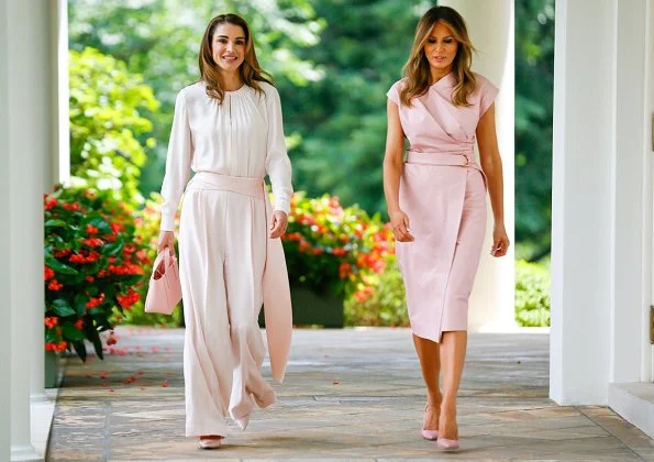 Queen Rania wore a baby pink jumpsuit by Adeam. First Lady Melania Trump wore a pink sleeveless wrap around dress by Proenza Schouler