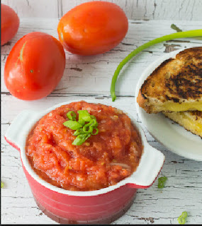 A flavorful tomato choka made from roasted tomatoes combined with onion, garlic and hot peppers Finished tomato choka in a serving bowl