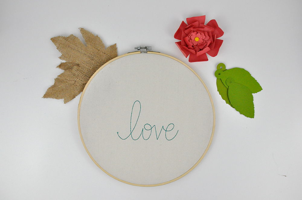 Love Embroidery Hoop Tutorial with burlap leaves, and die cut flowers and leaves. Designed by Jen Gallacher. 15 Minute Craft: Embroidery Hoop Decoration.