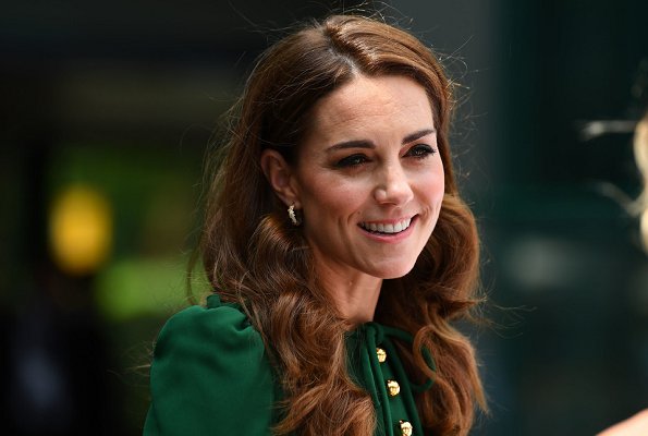 Kate Middleton wore a green midi dress by Dolce & Gabbana. Meghan Markle wore a print midi skirt by Hugo Boss