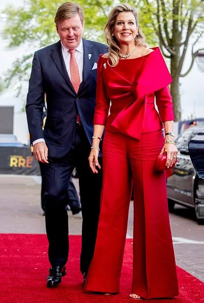 Queen Maxima wore a red top and red trousers. by Natan.Sarah's clutch bag. Carré Royal Theatre and around Amstel River