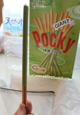 Green tea giant pocky unwrapped and holding with my hand