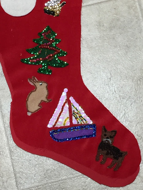 Beads and sequins on red velveteen Christmas stockings.