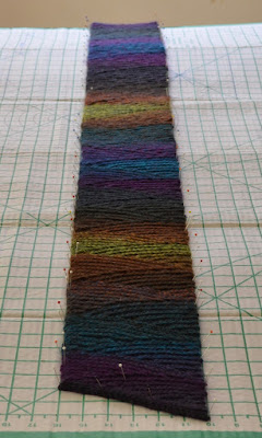 Long view of 'Shadow Spectrum' slip stitch scarf on the blocking board.