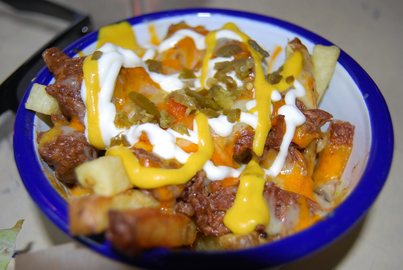 fries, pulled beef, sour cream, jalapeno