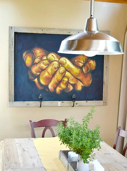 Reclaimed wooden framed painting over a farmhouse table