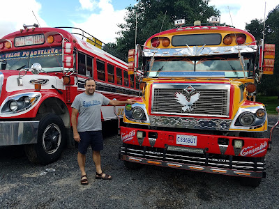 man standing with chicken buses guatemala