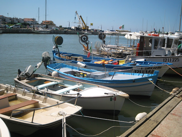 Small fishing boats lined one next to each other 