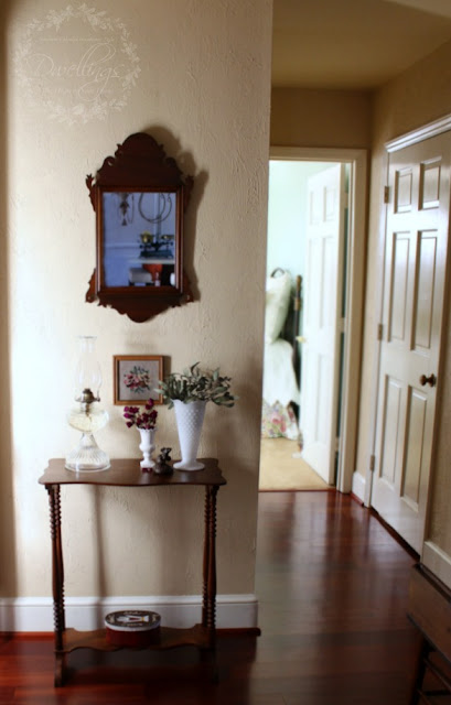 Dried roses and seeded eucalyptus vignette in the hallway.